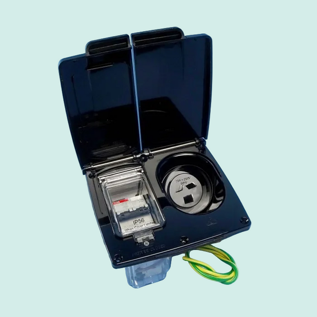 Electrical outlet with cover open on a blue background